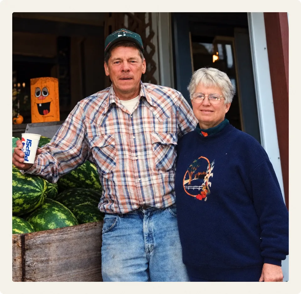 Gordy and Dorothy Kopischke at the market with a bin of watermelons