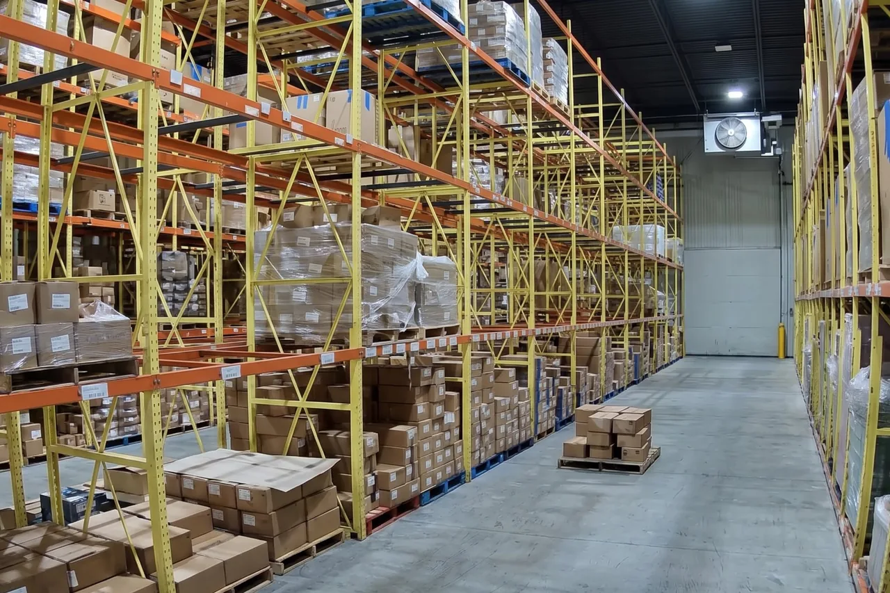 Pallet racks with mixed cases and shrink-wrapped loads in a cold storage room